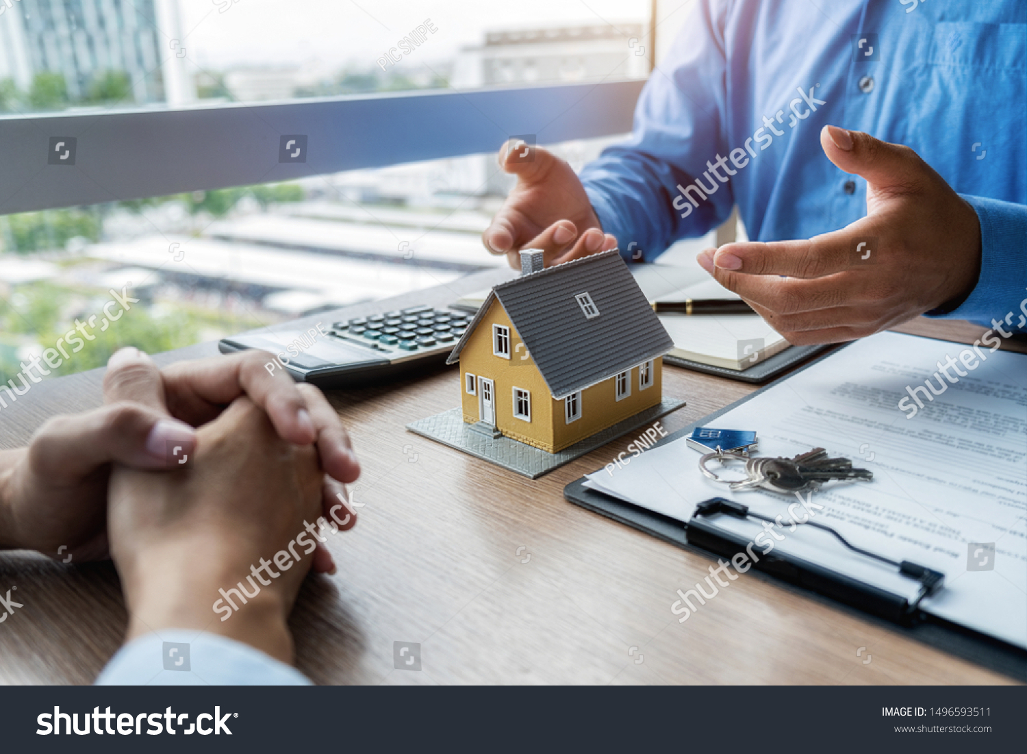 House model with agent and customer discussing for contract to buy get insurance or loan real estate or property background