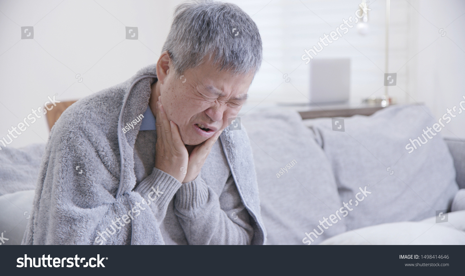 asian elderly man has sore throat and feel very uncomfortable at home