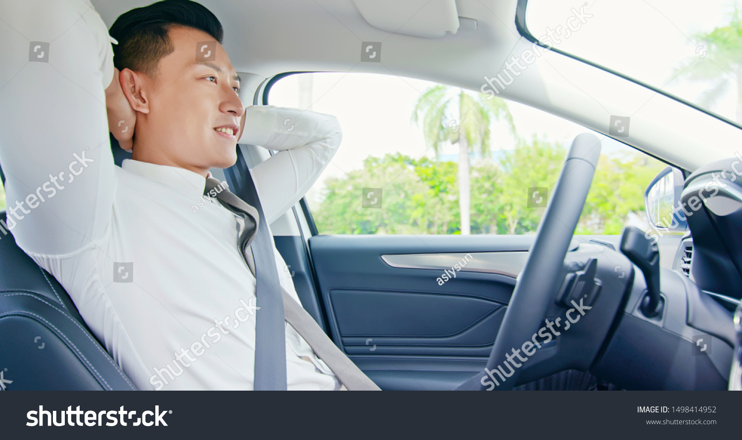 confident business asian man enjoy to drive an self-driving smart car