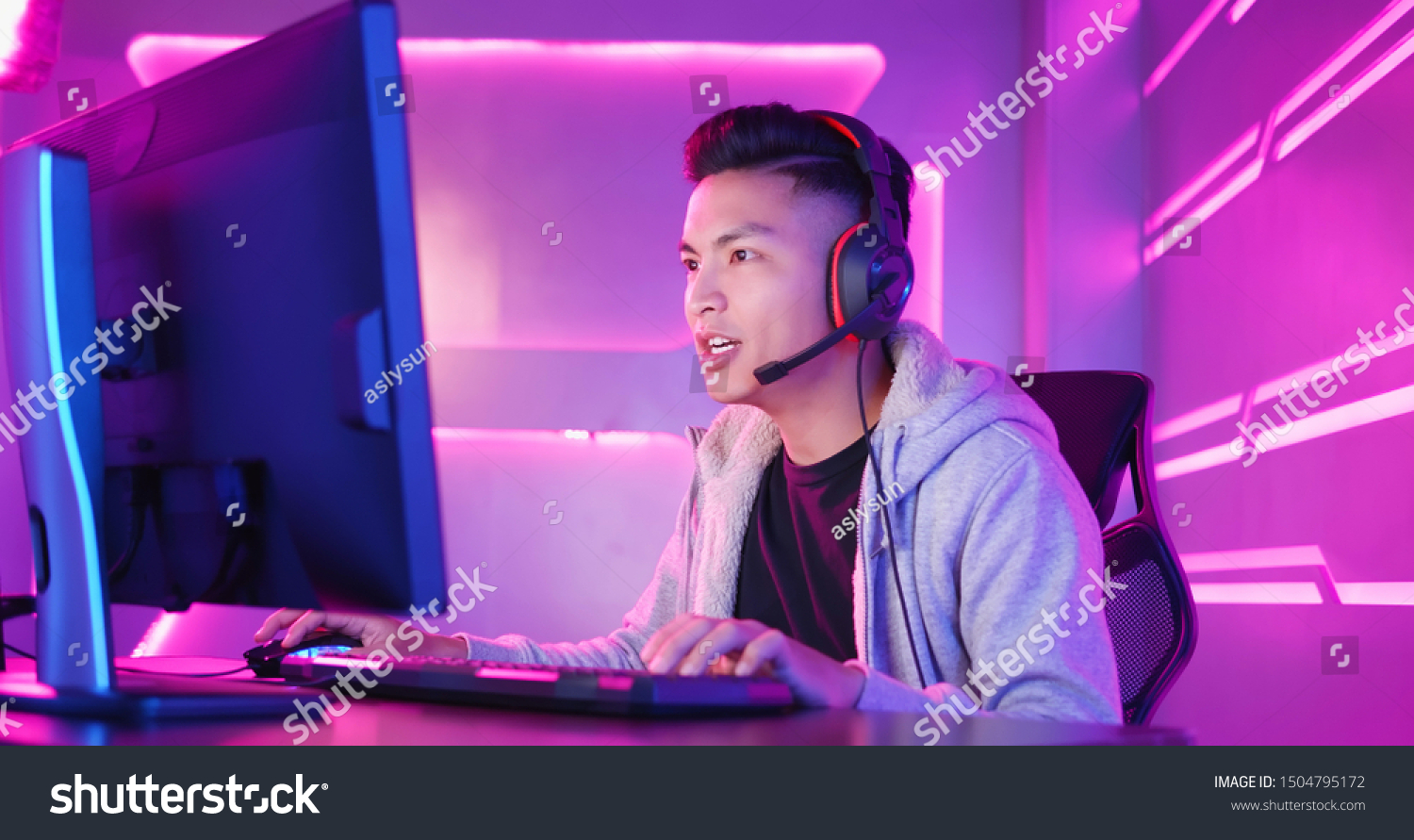 Young Asian Handsome Pro Gamer Playing in Online Video Game