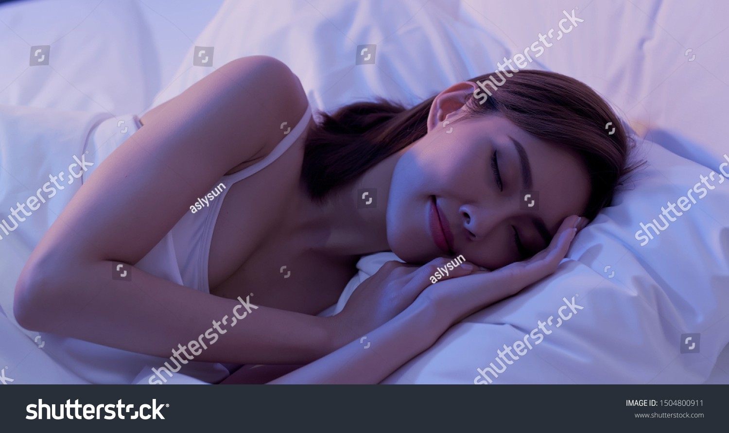 beauty asian woman has a good sleep on the bed at night