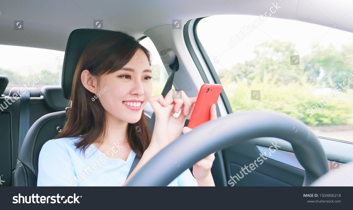Asian woman experience to riding an autonomous self driving car and use smart phone