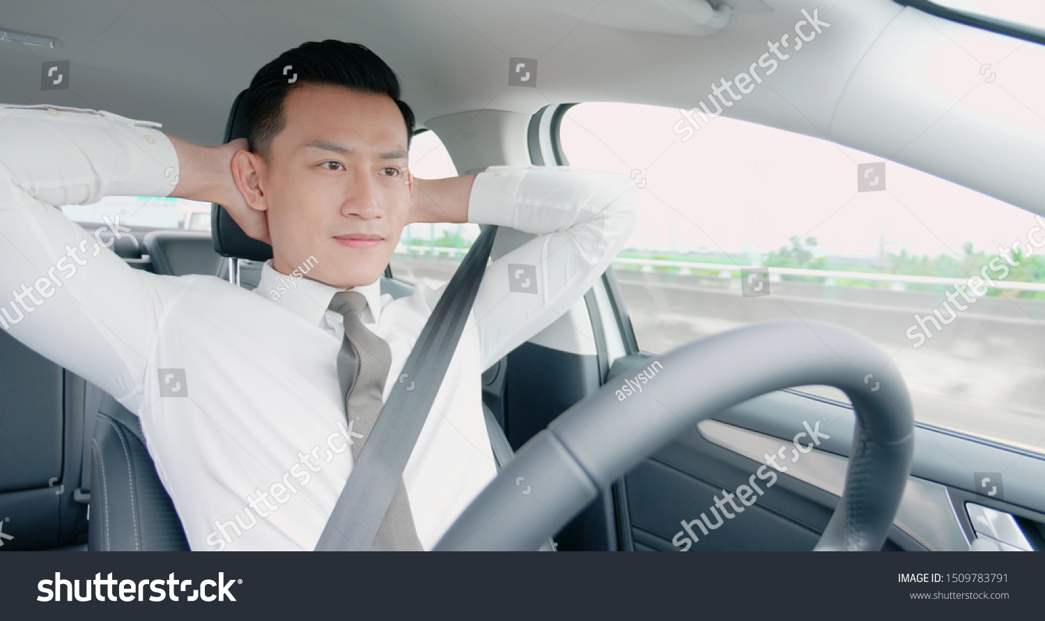 confident business asian man enjoy to drive an auto self-driving smart car in highway