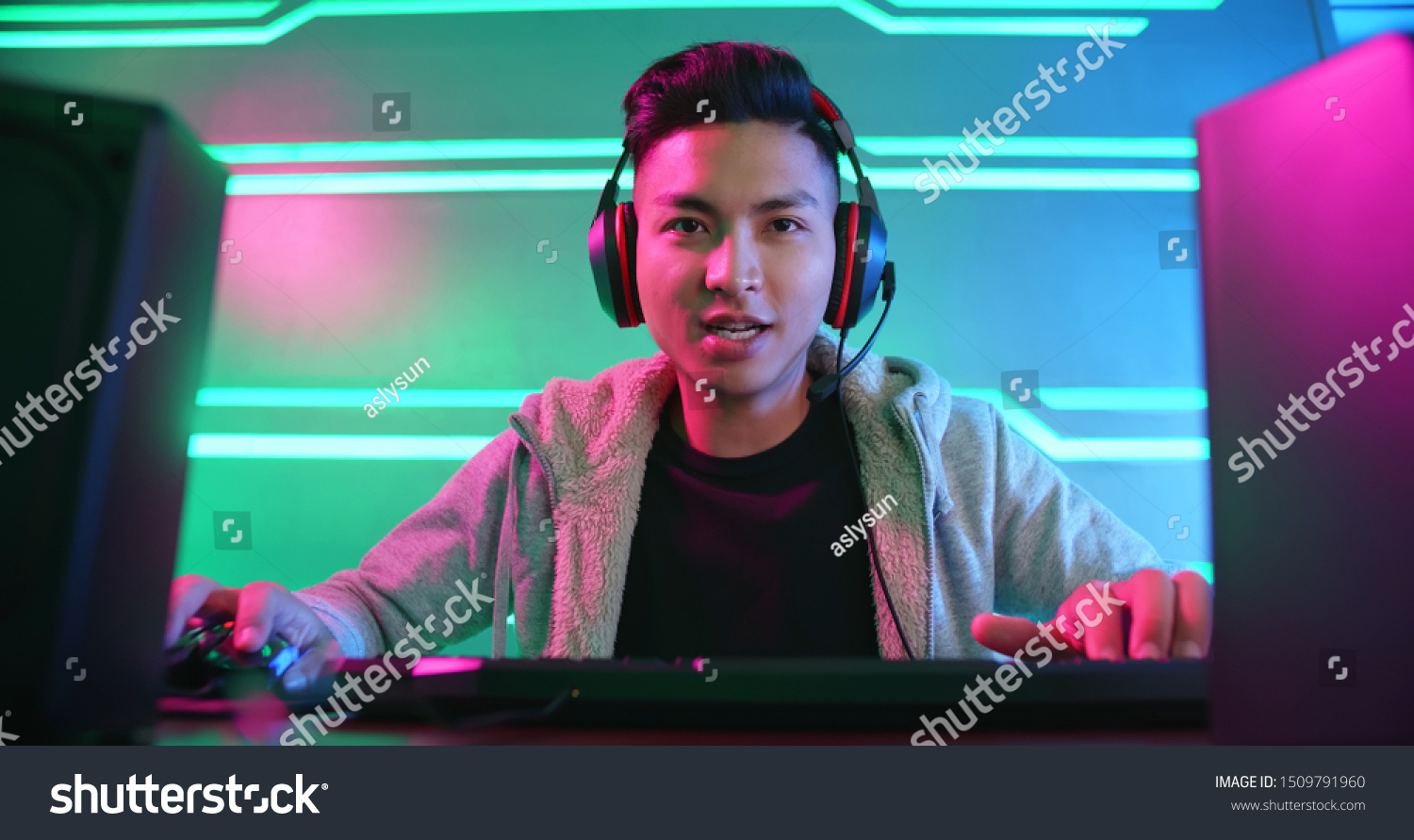 Young Asian Handsome Pro Gamer Playing in Online Video Game
