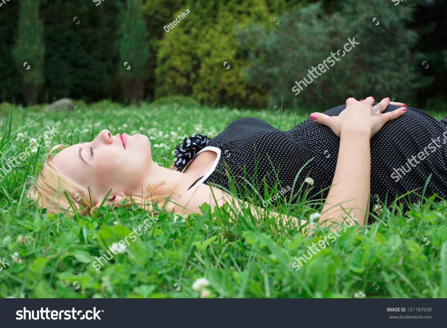 Pregnant woman lying on the grass