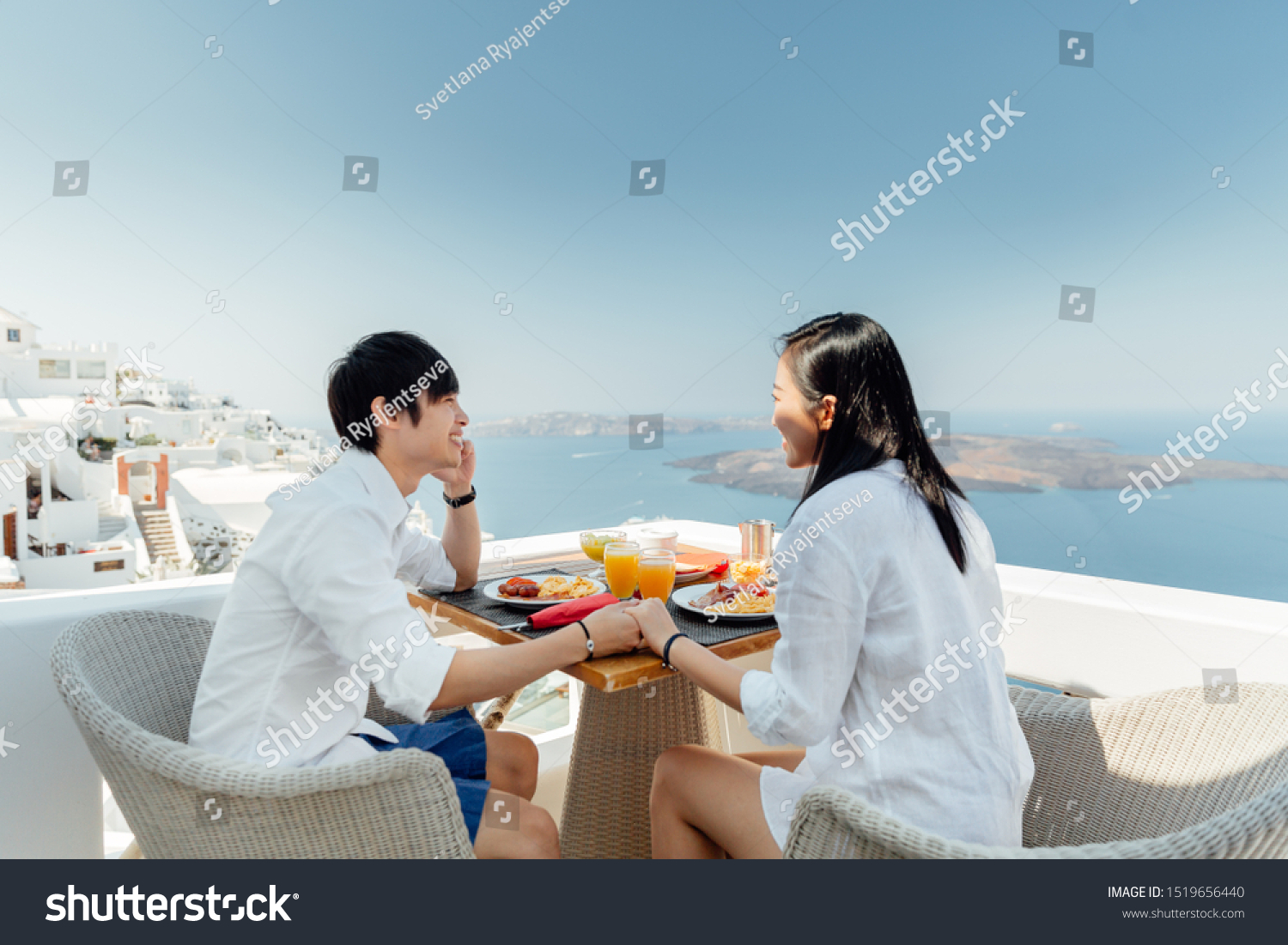 Beautiful couple having breakfast on vacation on Santorini Island  Greece. 
