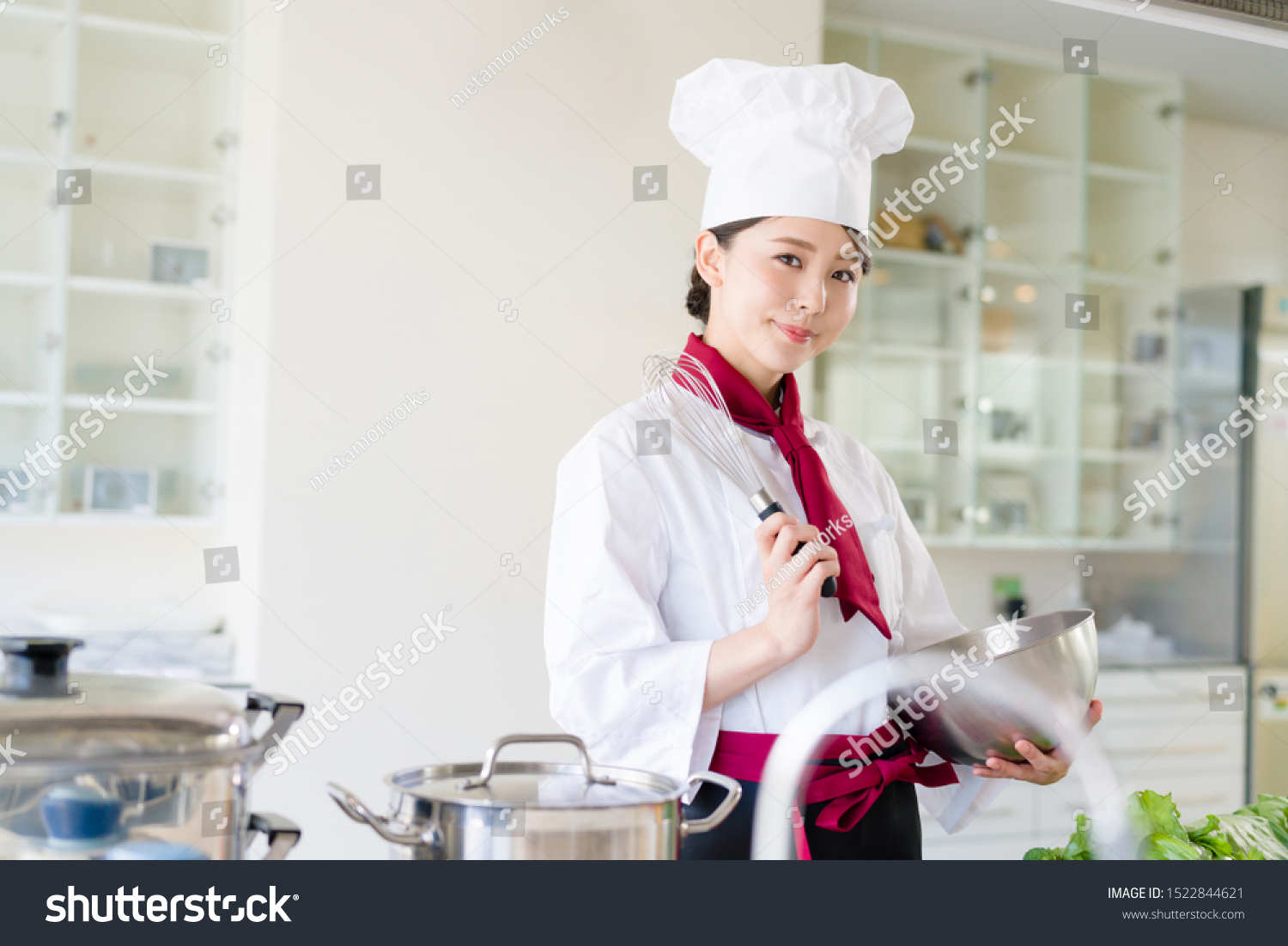 Asian female chef in kitchen. Cooking. Restaurant.