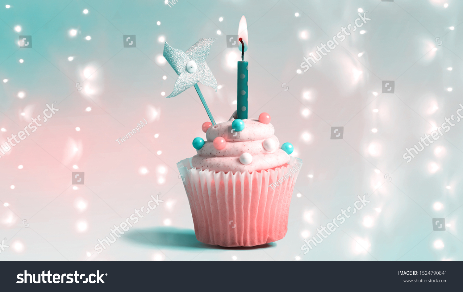 Celebratory cupcake with a decorative lit candle