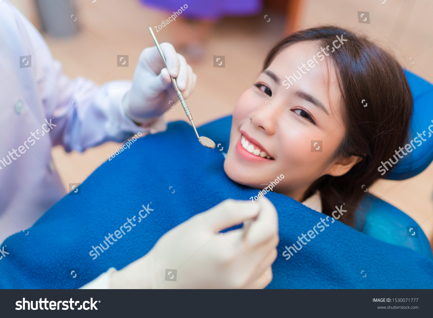Closeup smile of woman having dental teeth examined dentist check-up via excavator in Clinic her patient