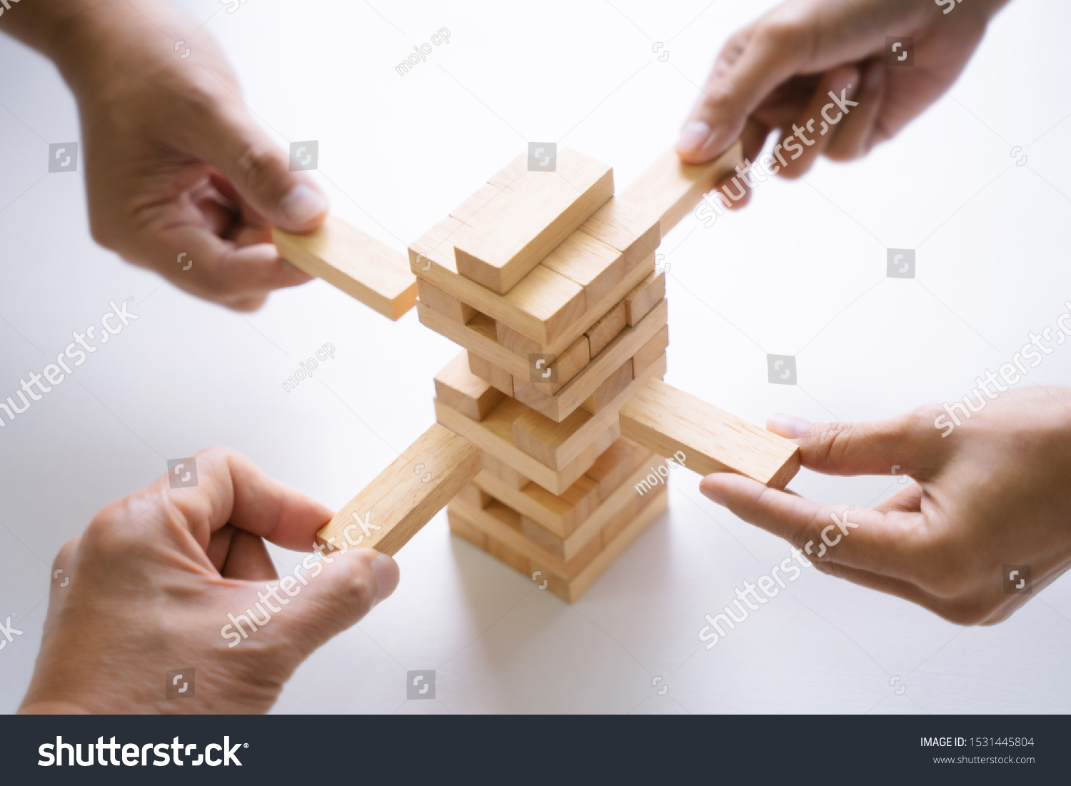 Group of people building up the tower  Business risk and strategy concept.