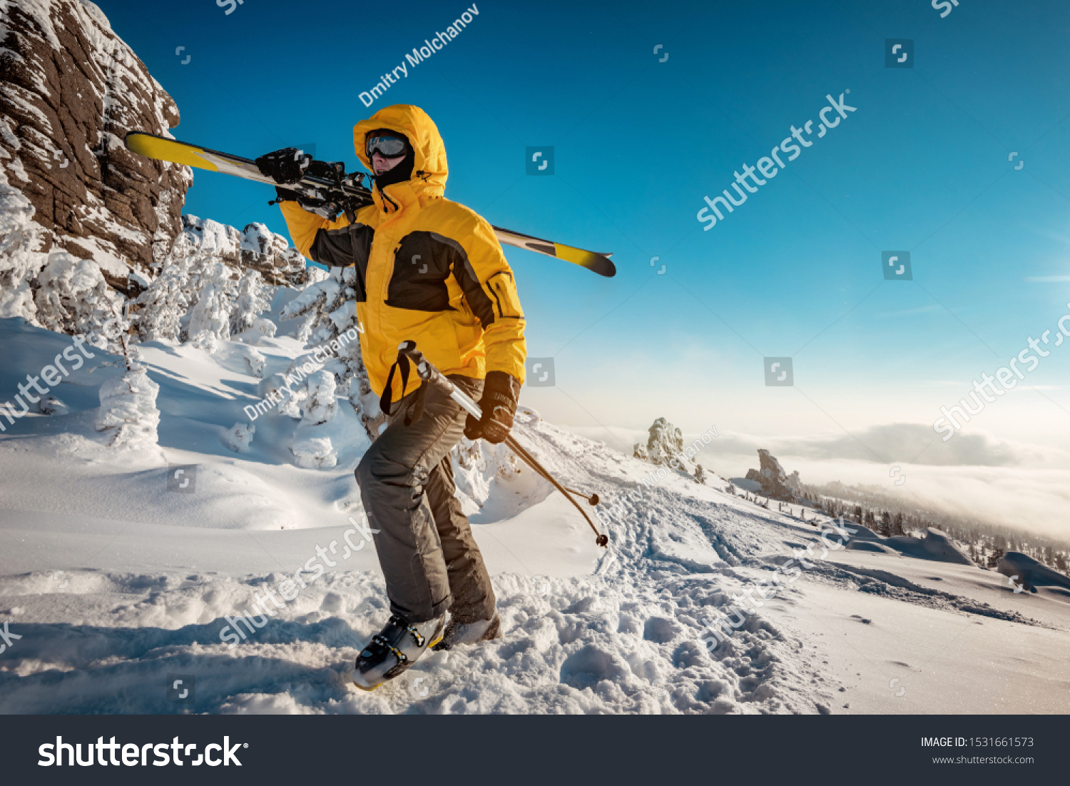 Skier with ski in hands goes uphill for backcountry skiing. Ski resort concept