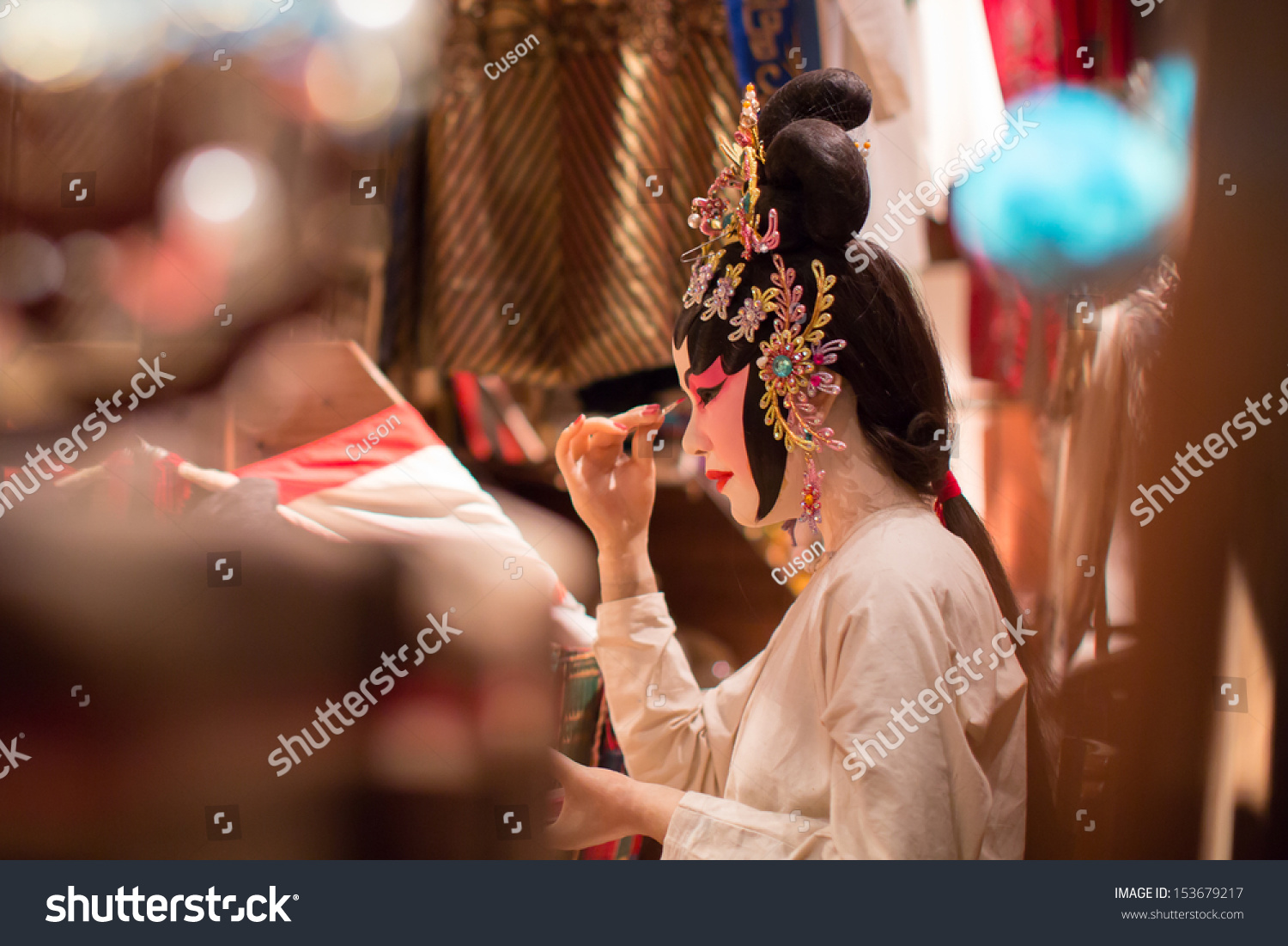 Chinese Opera Dummy is doing the make up. This is a dummy  not a real person.