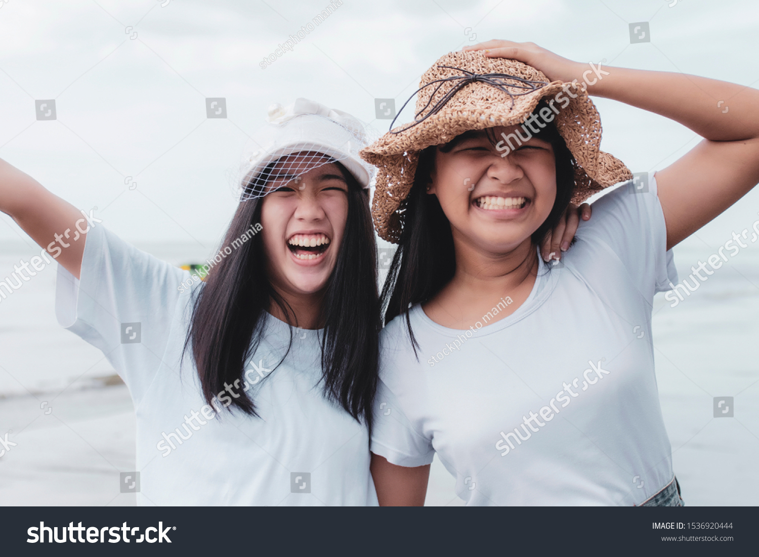 two cheerful asian teenager happiness on vacation sea beach