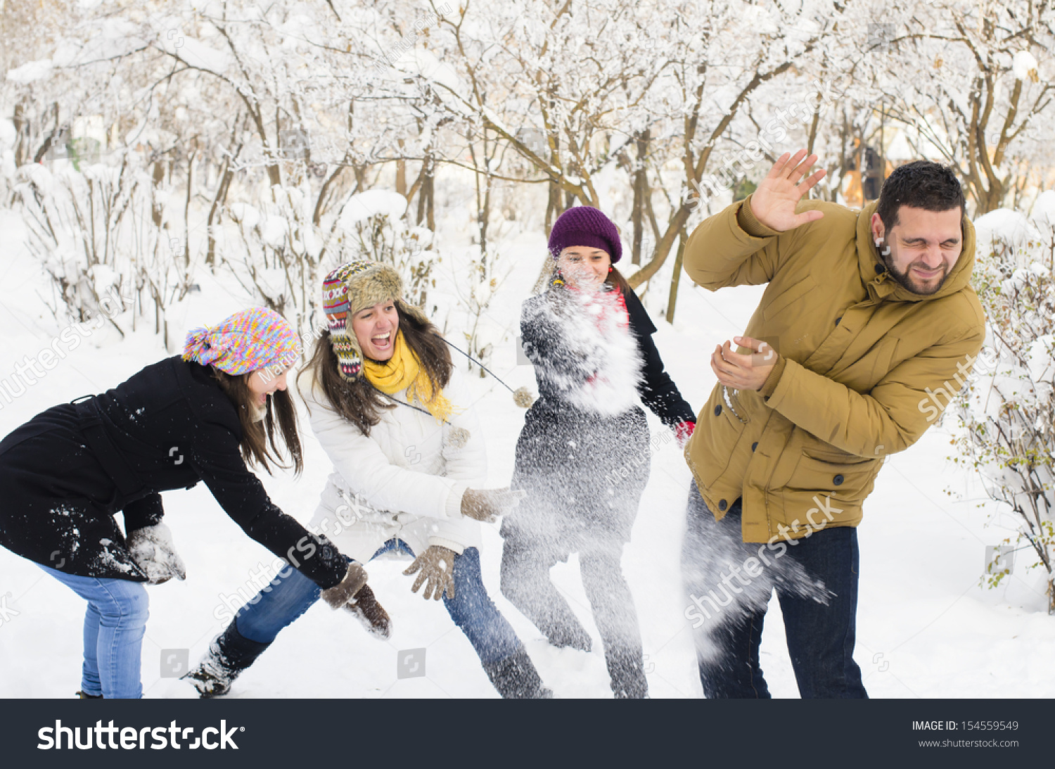 A group of young people playing in the snow