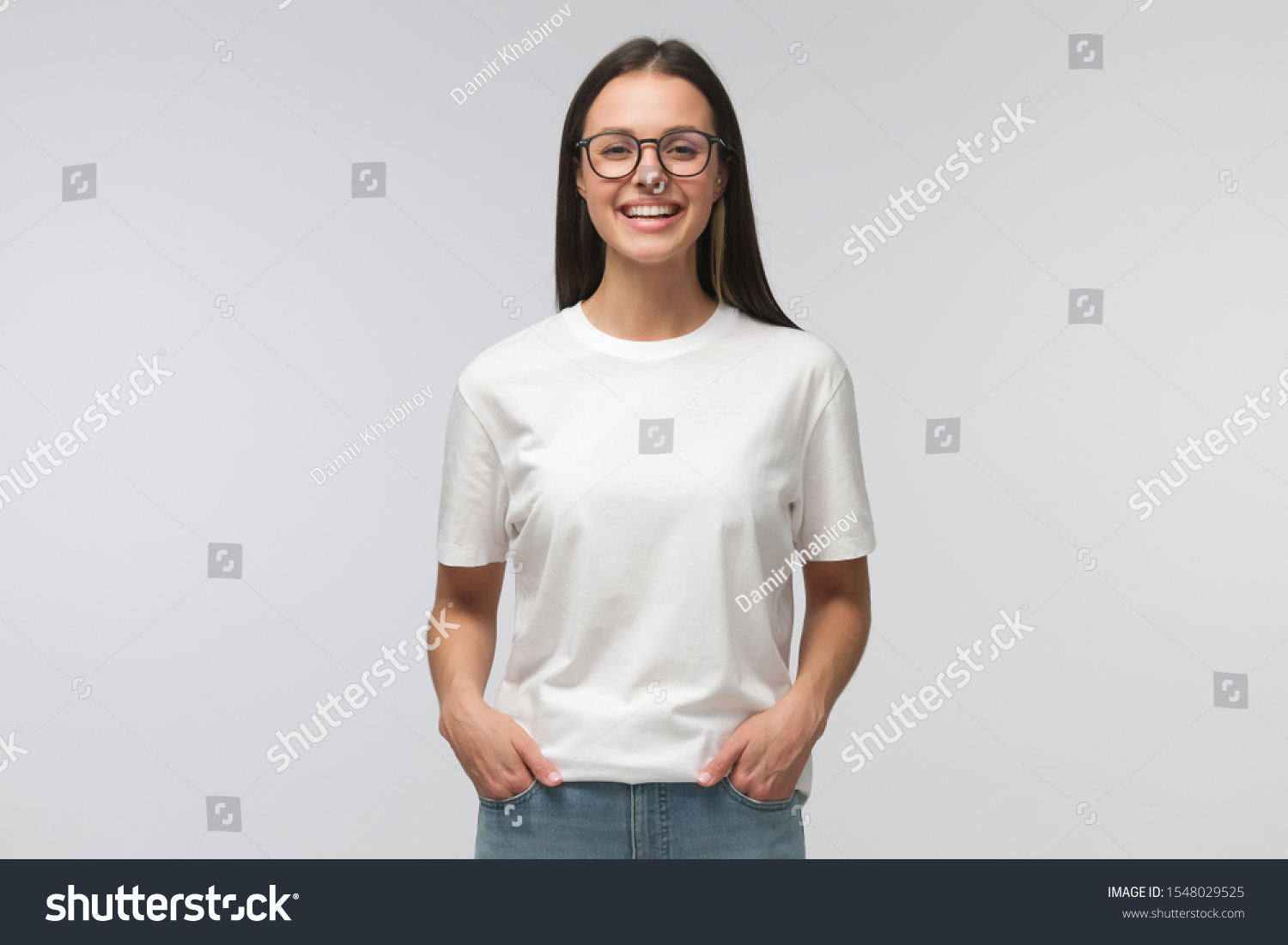 young laughing woman standing with hands in pockets