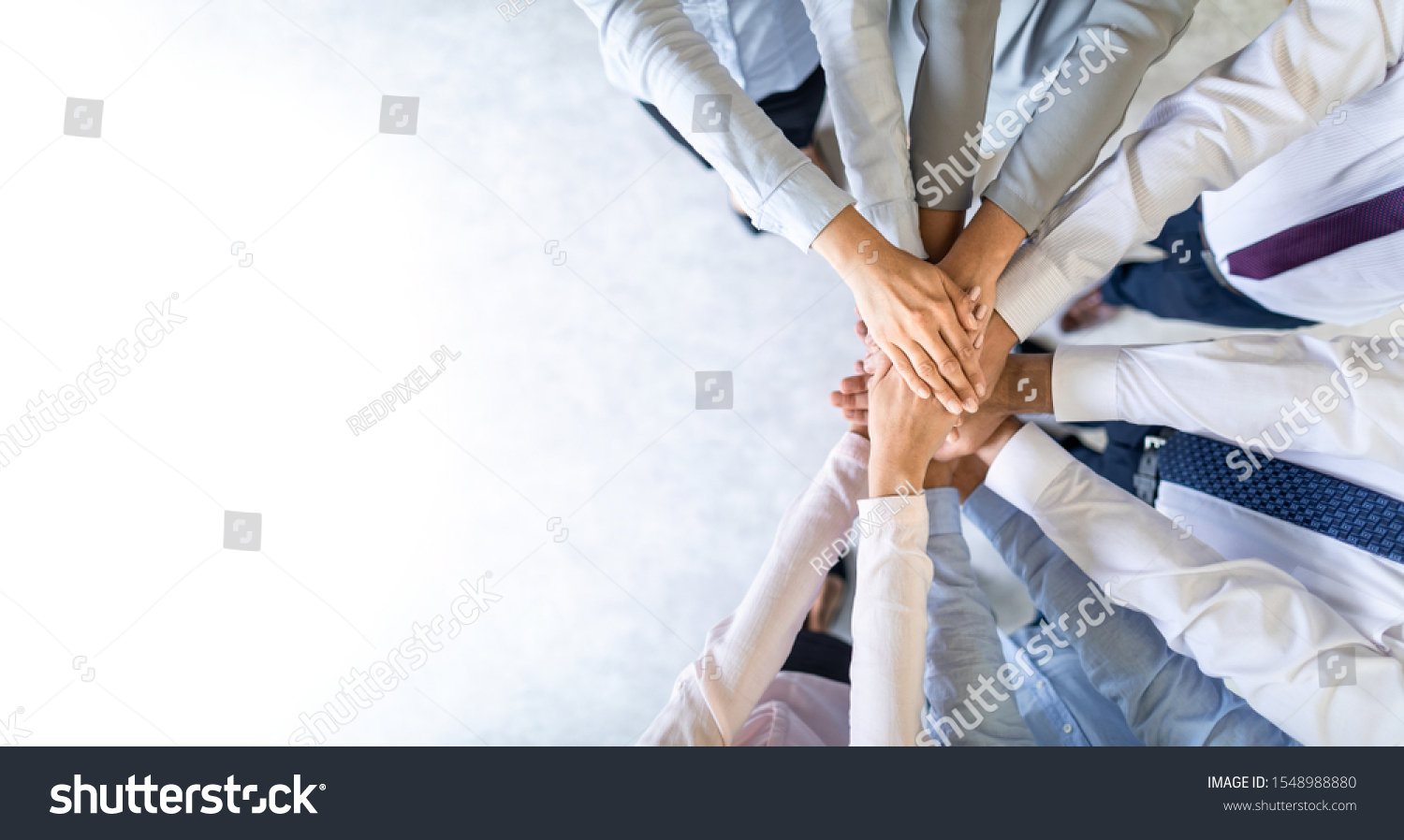 Close up top view of young business people putting their hands together. Stack of hands. Unity and teamwork concept.