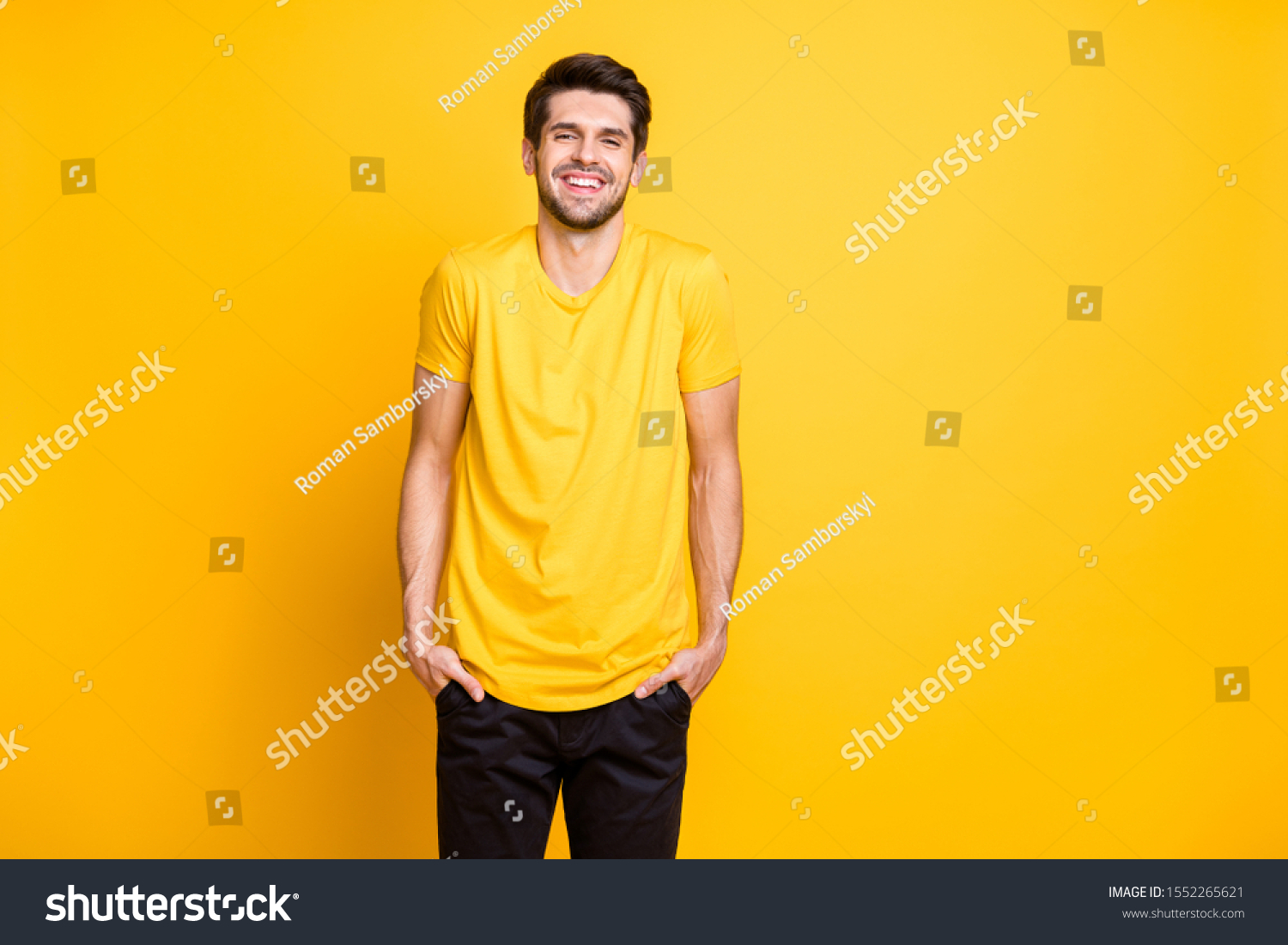 photo of amazing handsome guy holding hands in pockets cool