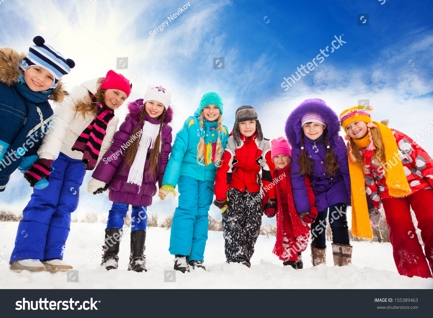 Large group of kids boys and girls 5-10 years old bending down holding hands standing together in a row