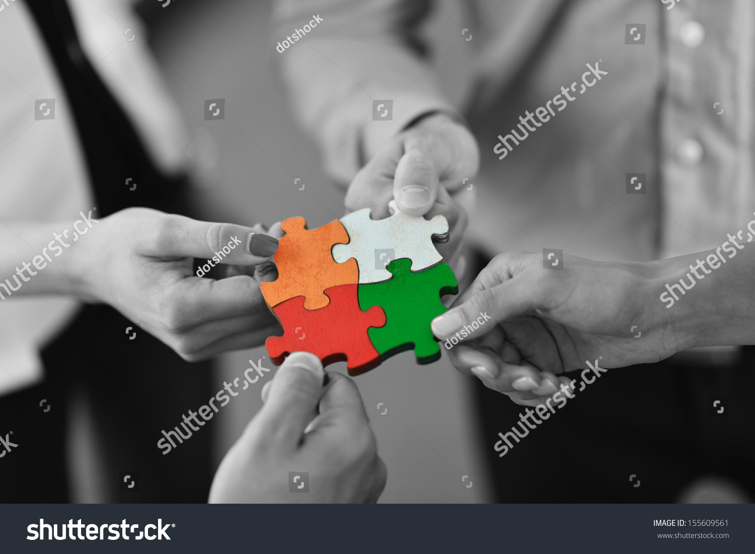 Group of business people assembling jigsaw puzzle and represent team support and help concept