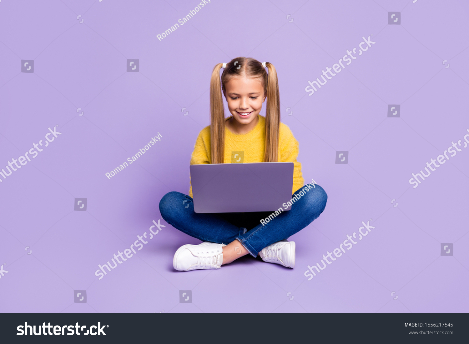 Full length photo of positive interested kid sit legs crossed folded work her laptop read social media news wear casual style clothing isolated over violet color background