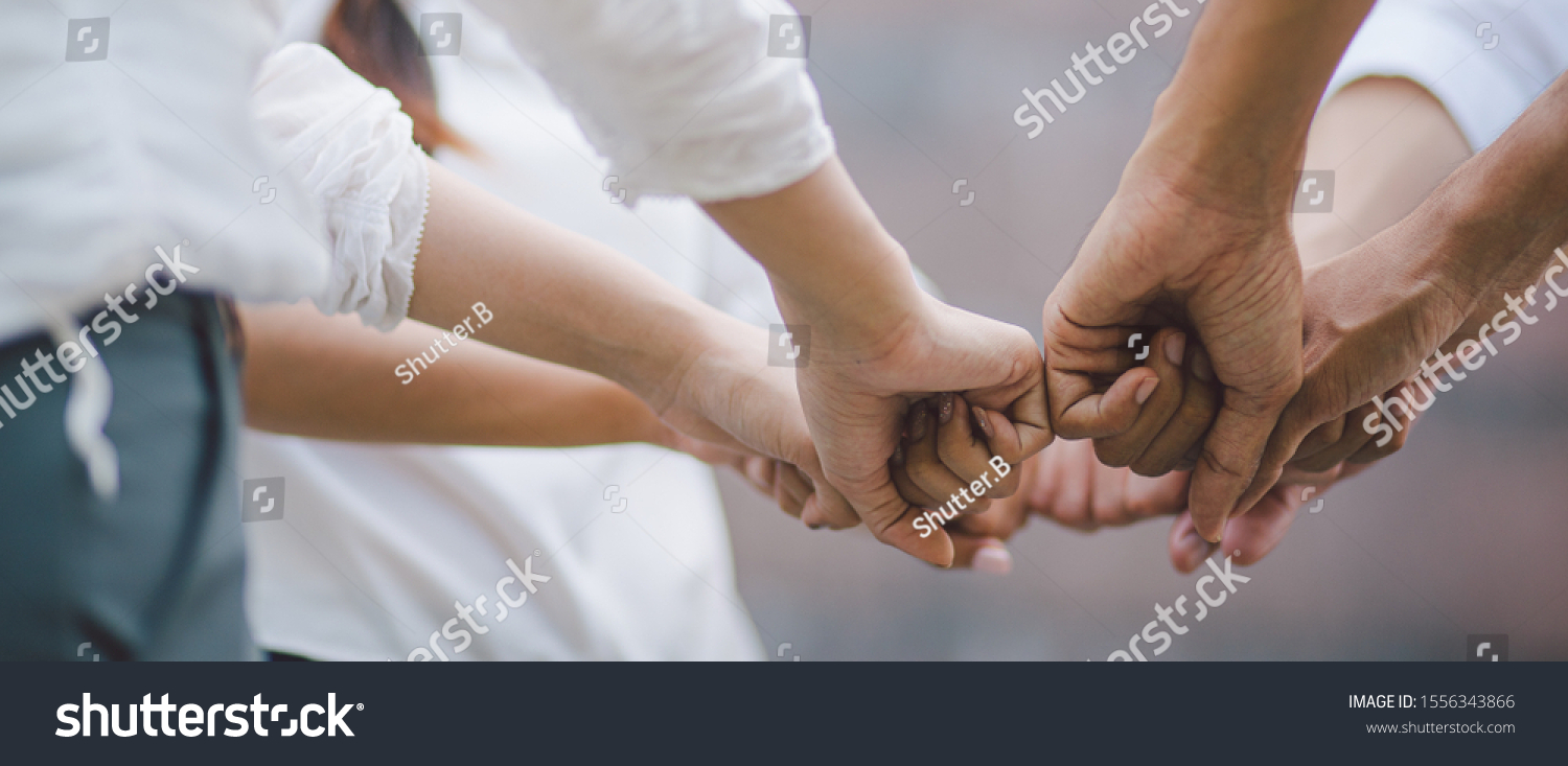 Panoramic teamwork business join hand together concept  Business team standing hands together  Volunteer charity work. People joining for cooperation success business.