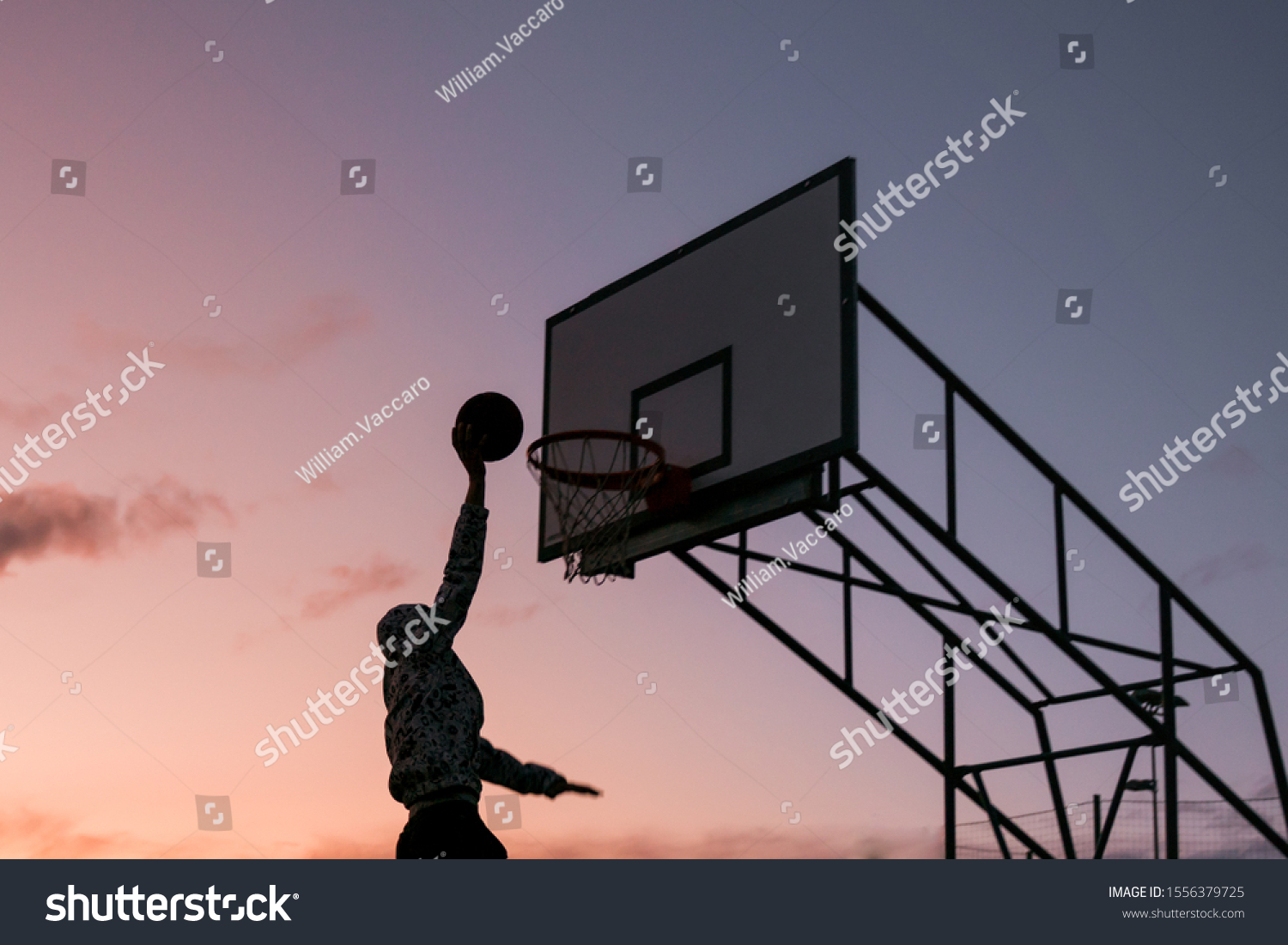 slam dunk basketball isolated sunset. Scoring silhouette dunking man outdoors
