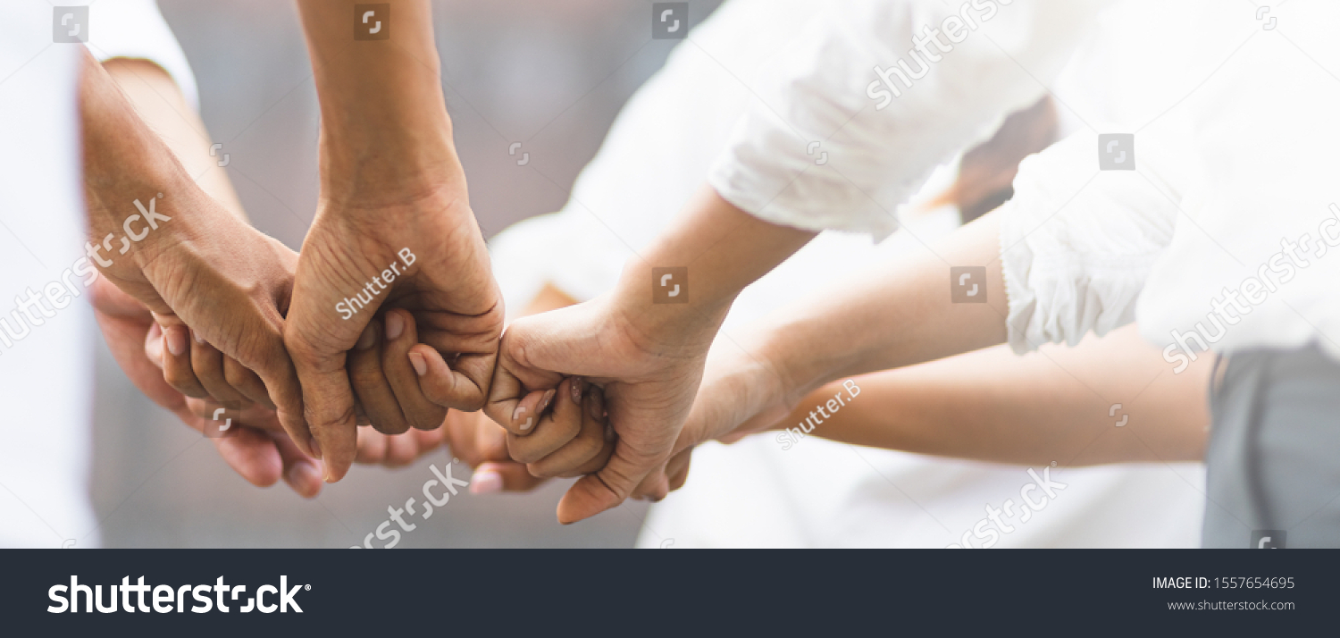 Panoramic teamwork business join hand together concept  Business team standing hands together  Volunteer charity work. People joining for cooperation success business.