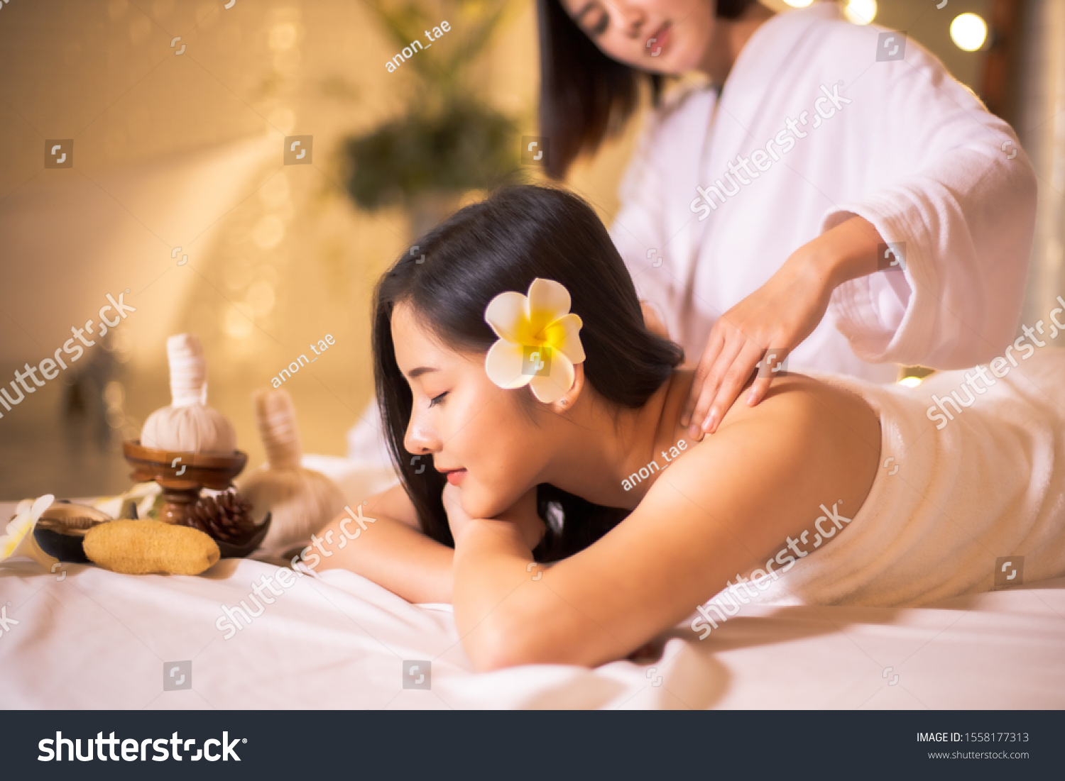 Asian Beautiful  young and healthy woman in spa salon. Massage treatment spa room  . Traditional medicine and healing concept.