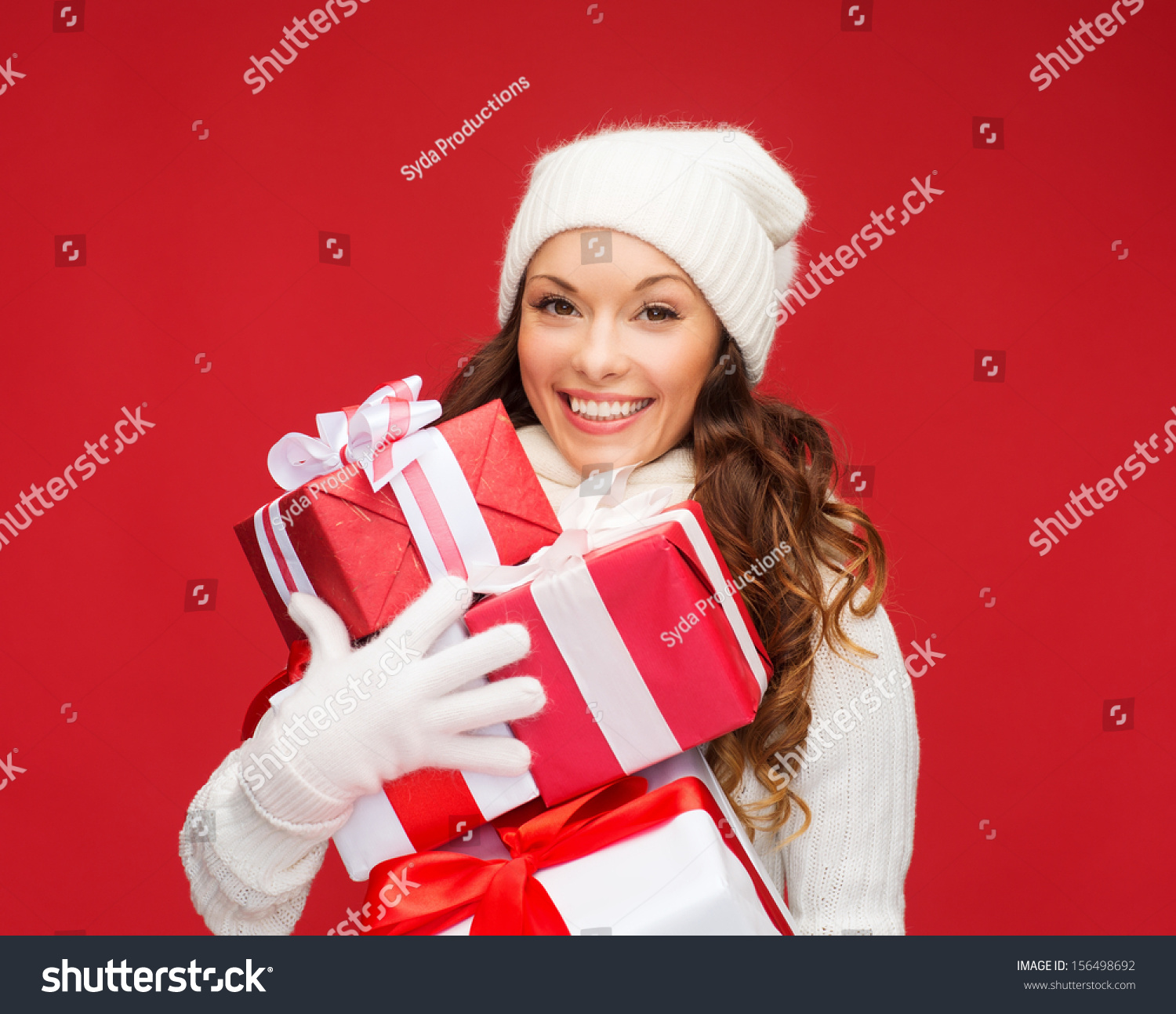 christmas x-mas winter happiness concept - smiling woman in sweater and hat with many gift boxes