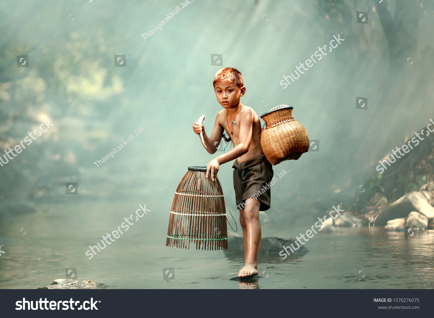 A boy is catching fish in a stream near his home. In the rural areas of ...