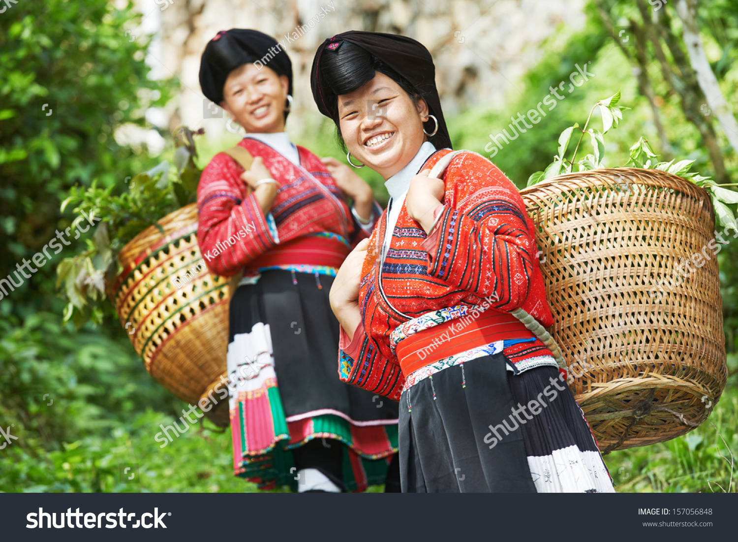 Group of happy chinese minority woman Yao in traditional dresses outdoors