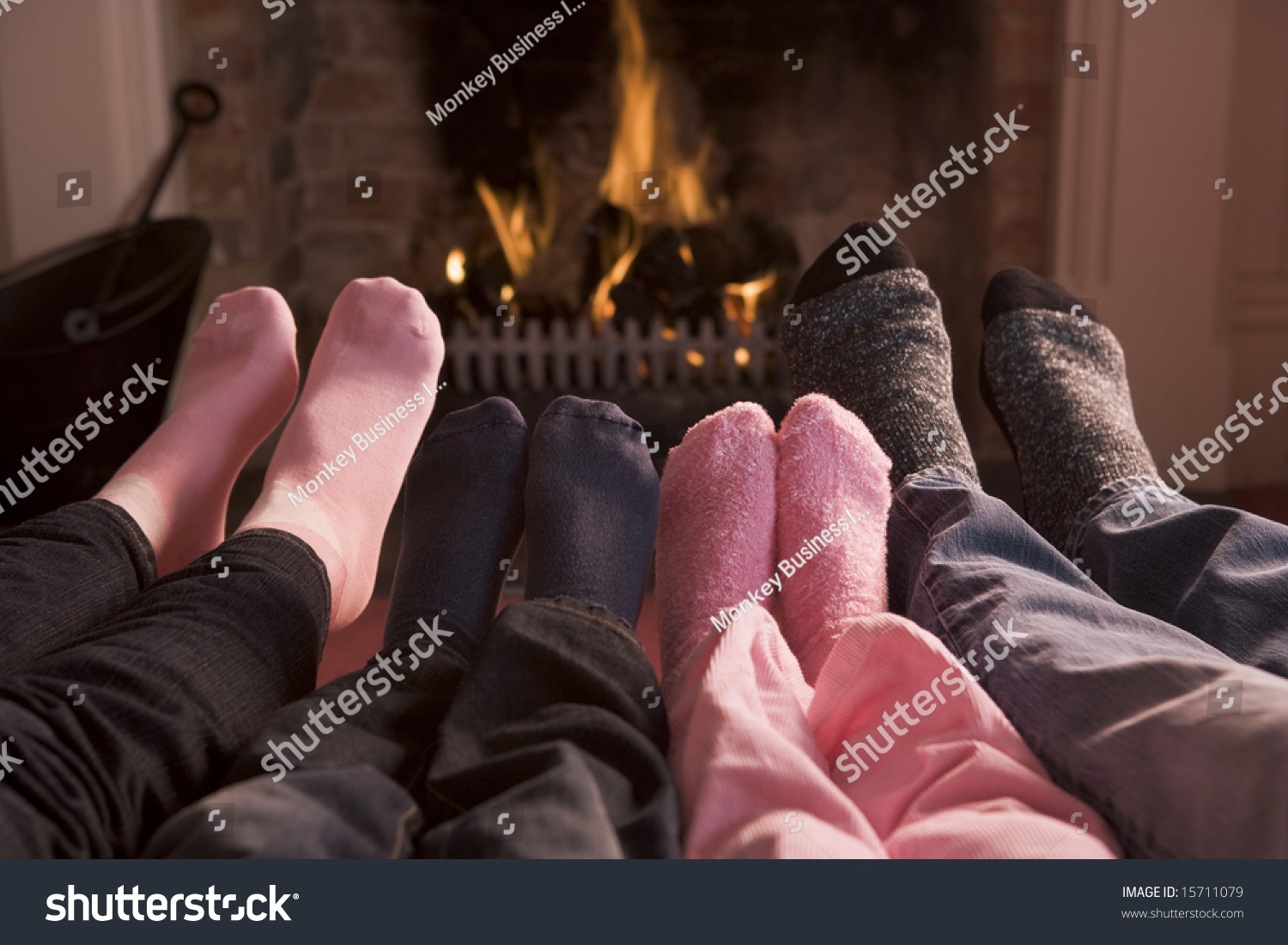 Family of Feet warming at a fireplace