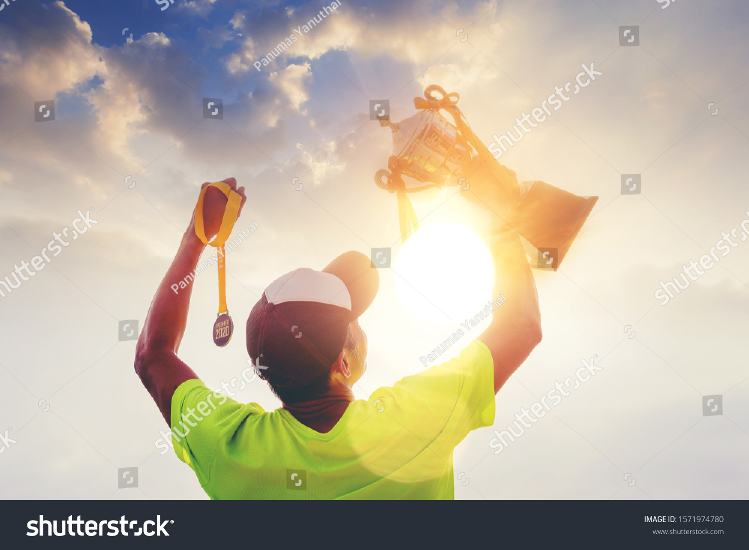 Silhouette marathon runner hand holding finisher trophy award and 2020 finisher medal celebrate his successful. Winning finisher concept
