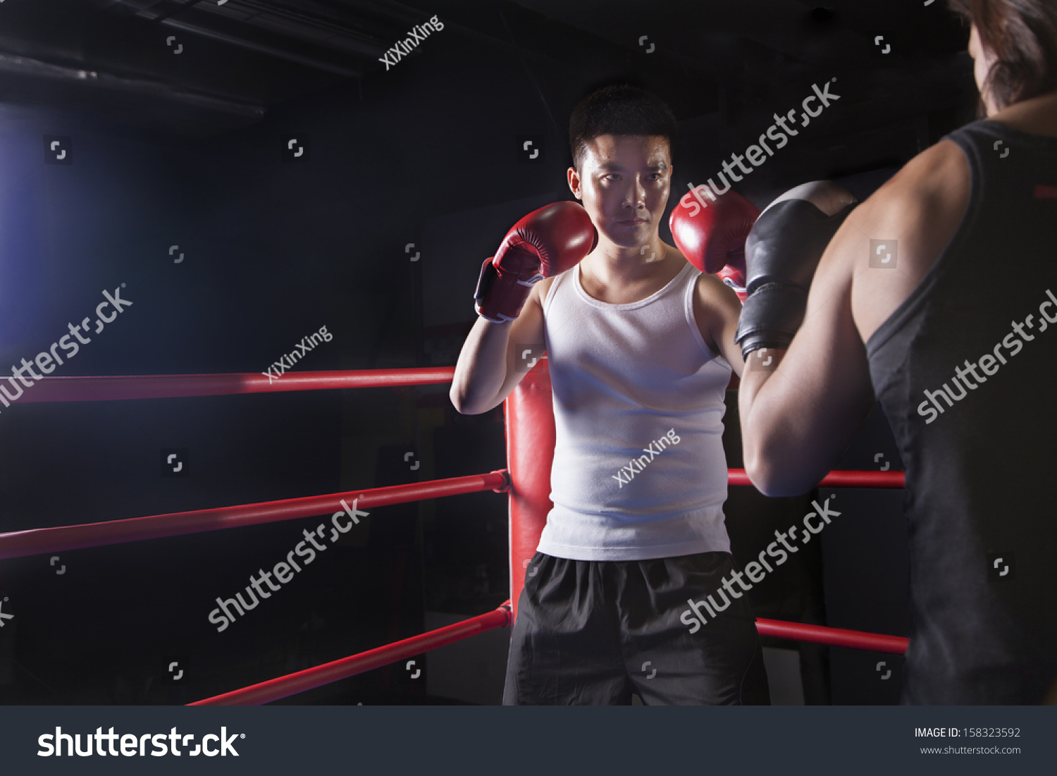 Two male boxers getting ready to box in the boxing ring 