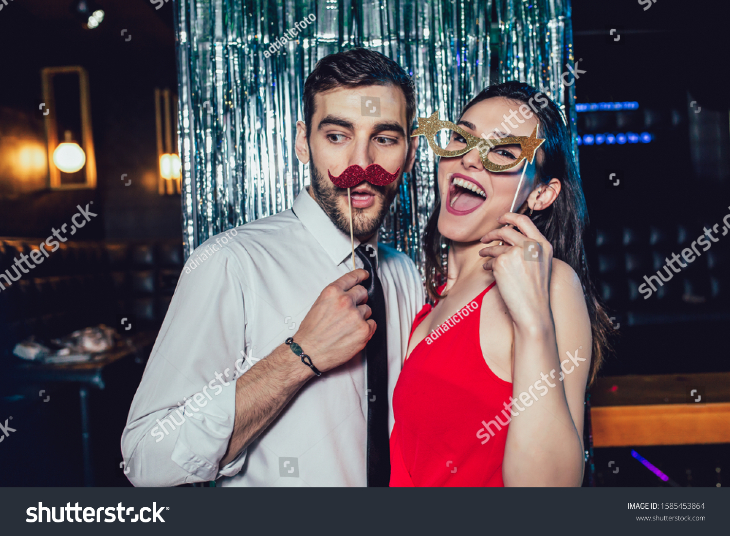 Couple dancing in the night club. Young man and woman having fun at pub ...