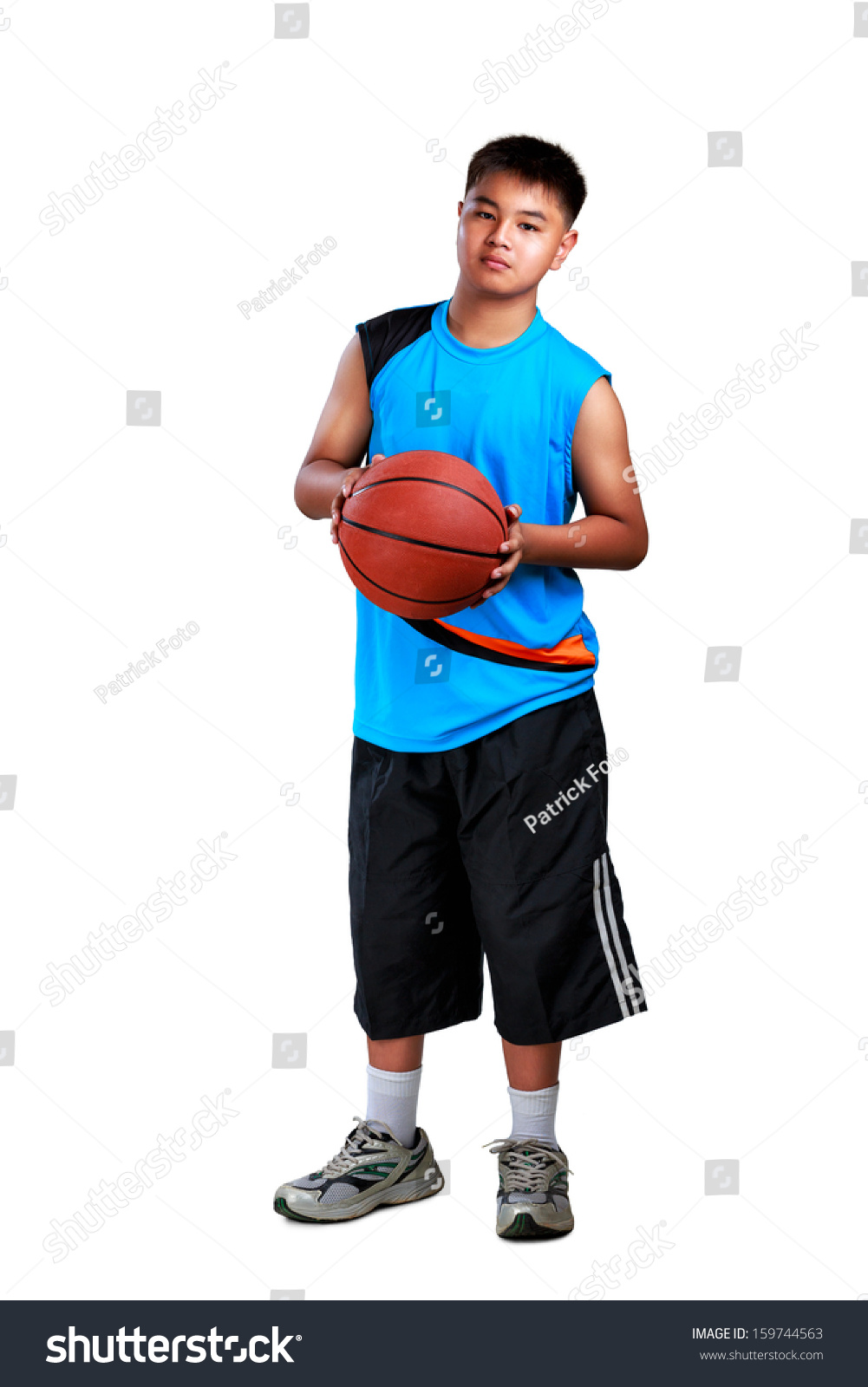 Young asian boy standing with basketball  Isolated over white