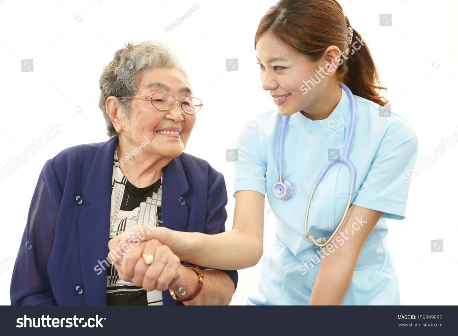 Smiling Asian medical doctor and senior woman