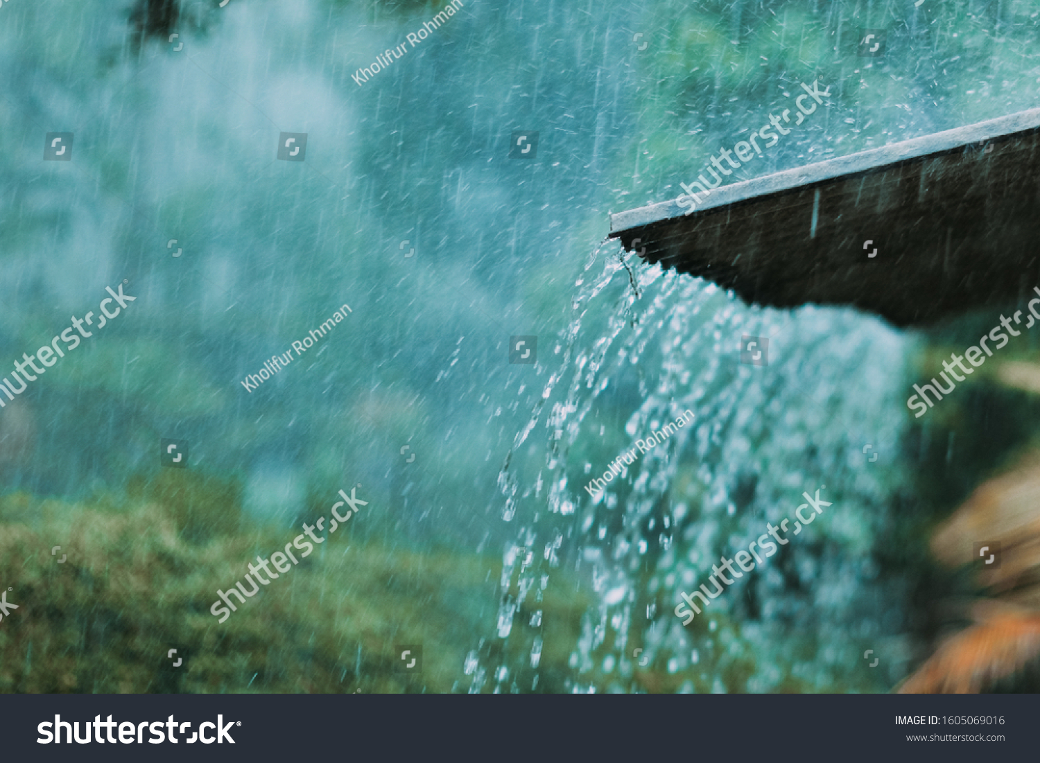 heavy rain pouring down over the roof