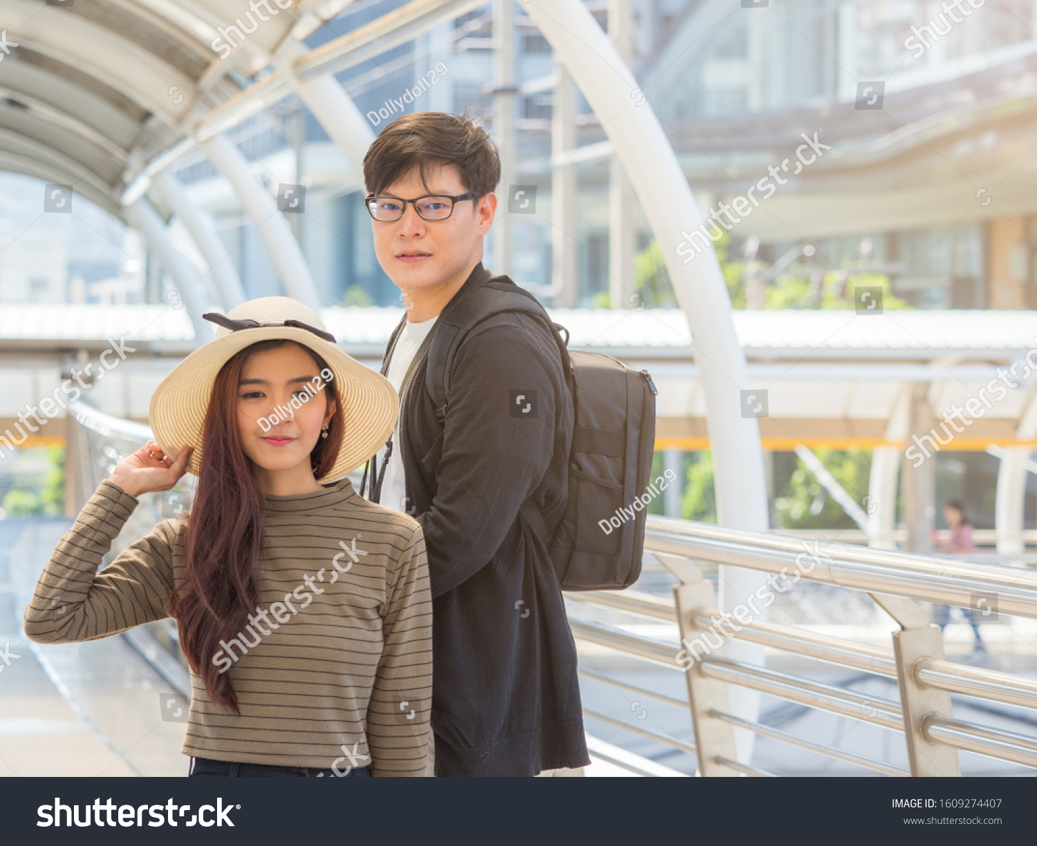 Young Asian couple looking at camera while travel in the city center. 