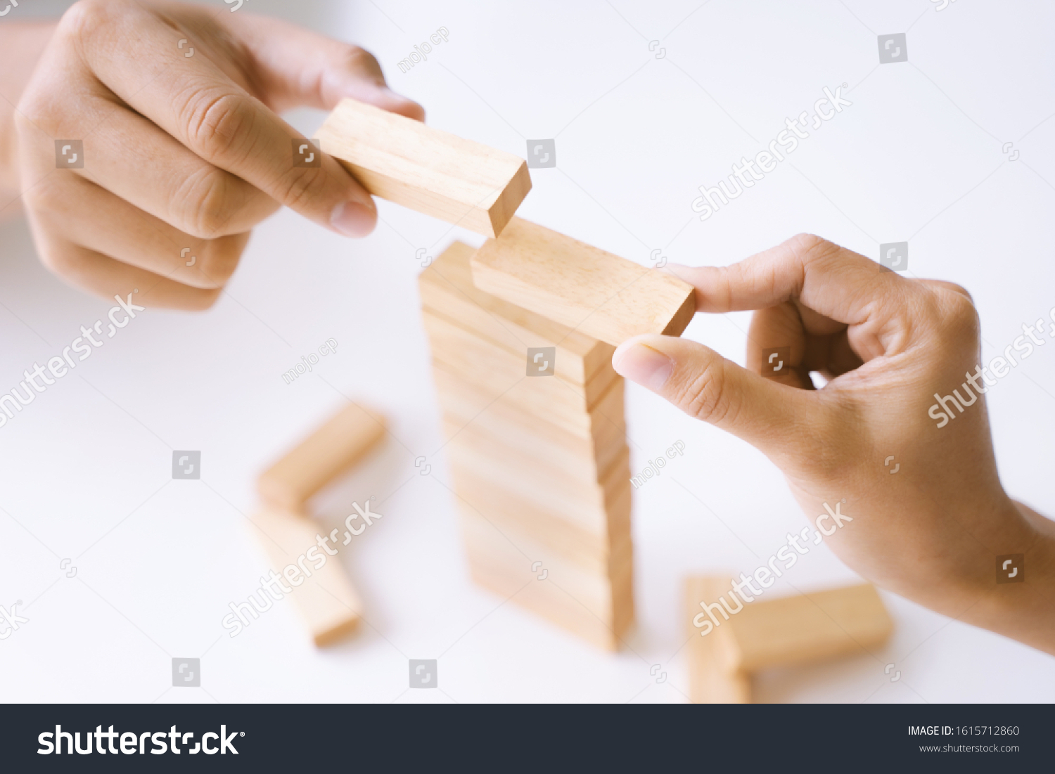 Group of people building up the tower  Business risk and strategy concept.