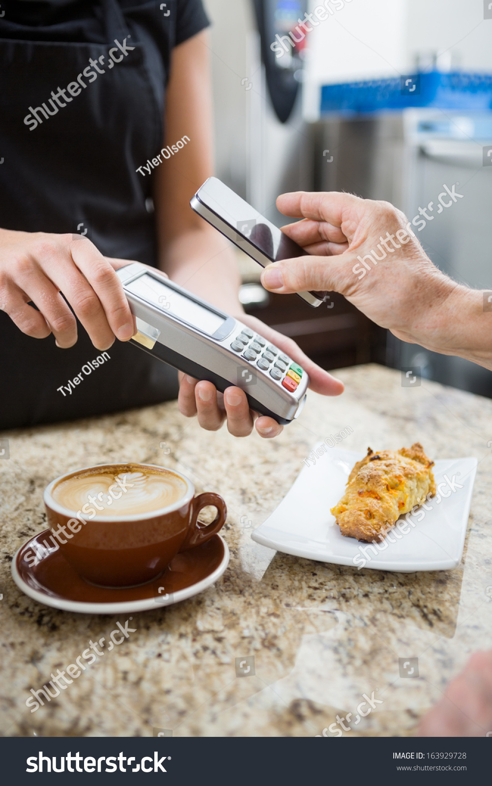Customer paying for coffee using NFC technology