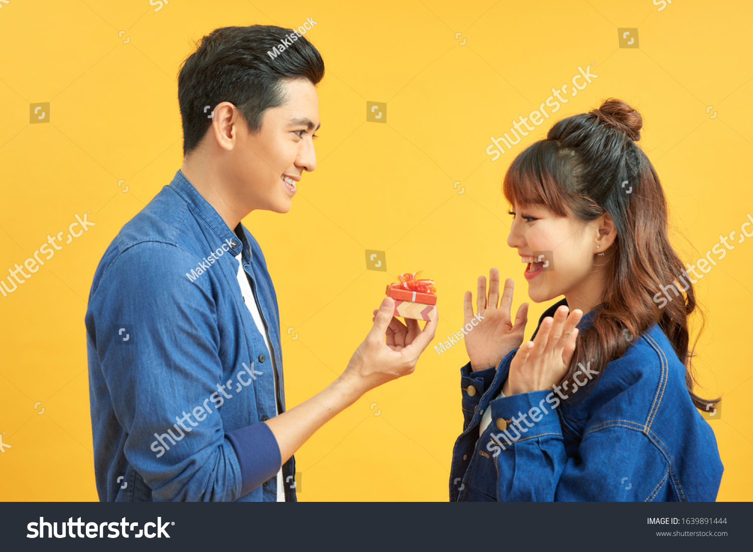 Young handsome asian man surprisingly ask her girlfriend for proposal.