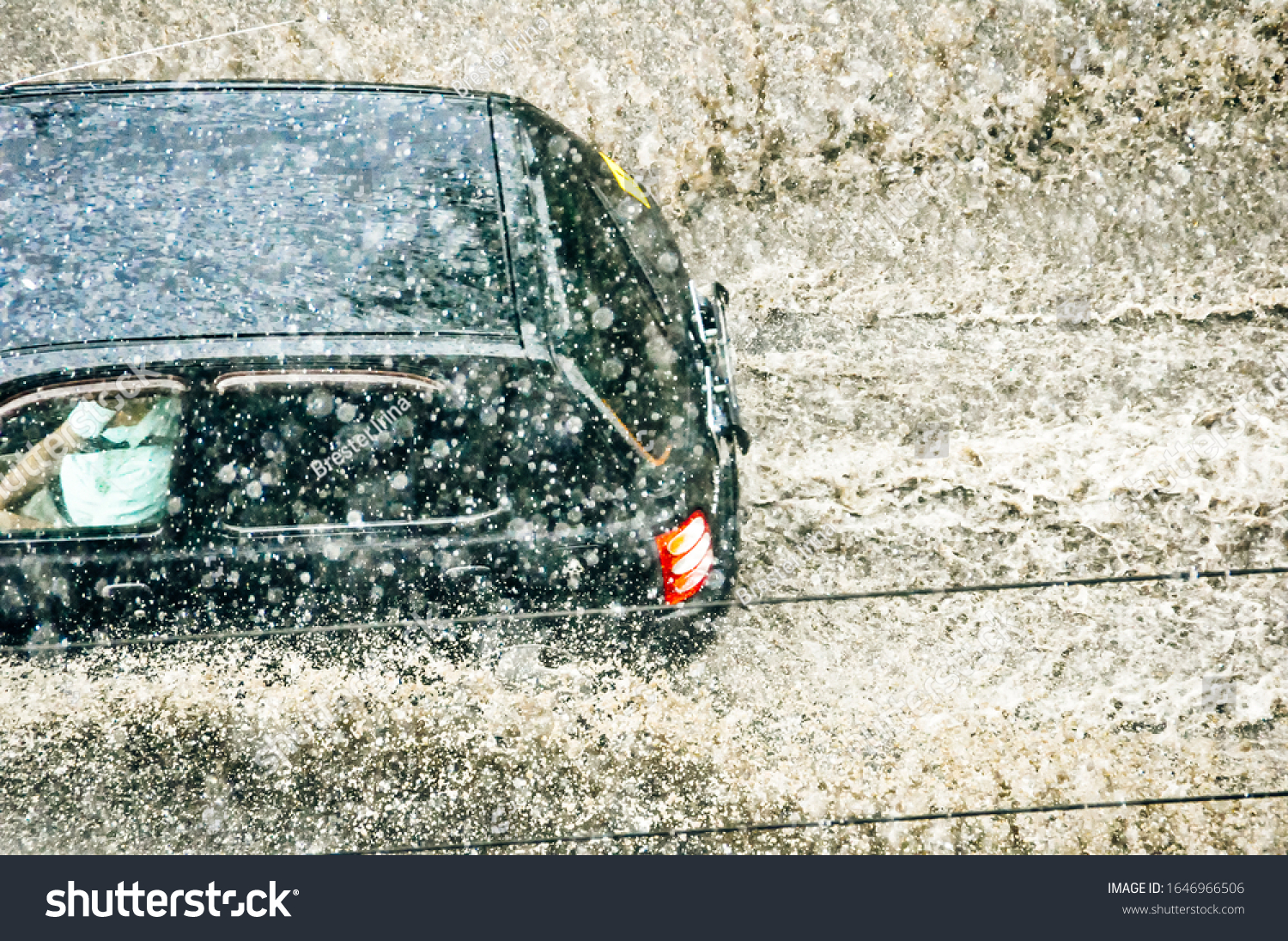 Car splash through flood water after heavy rain