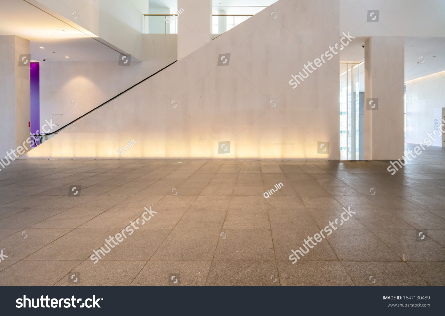 Empty floor tile and glass window in art center interior space