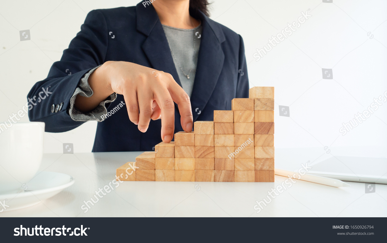 Business person's hand is climbing wooden block stairs. Concept of the success  career  goal achievement  hardworking