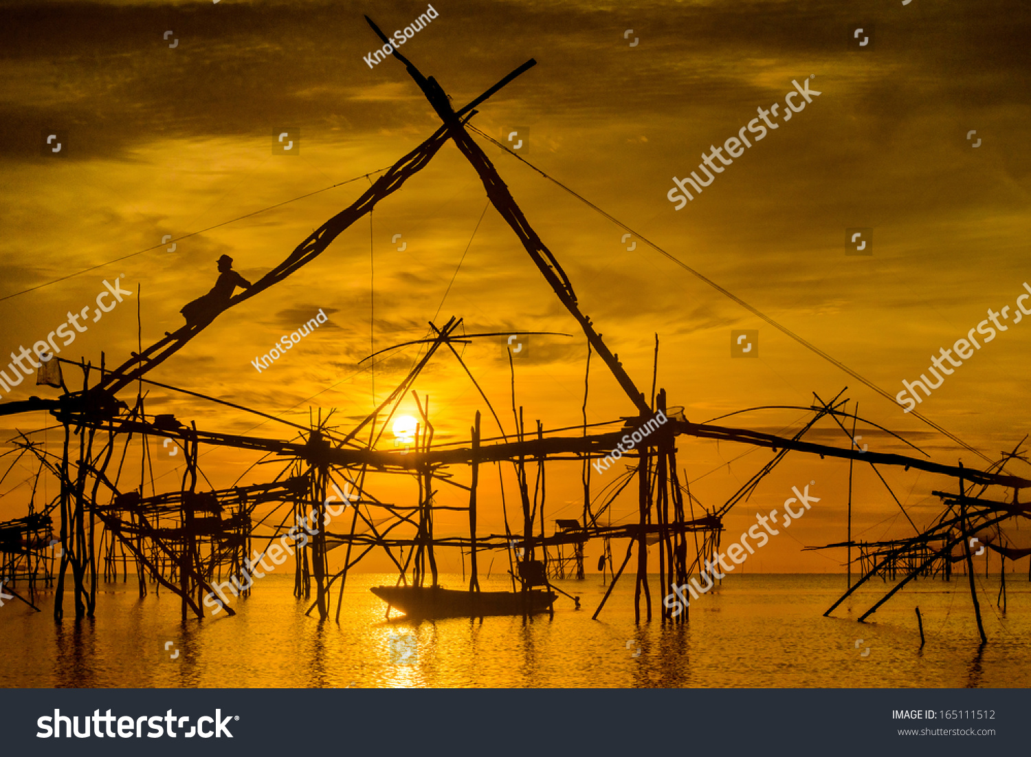 Silhouette of traditional fishing method using a bamboo square dip net in Patthalung  South of Thailand. taken in the morning with beautiful sky.