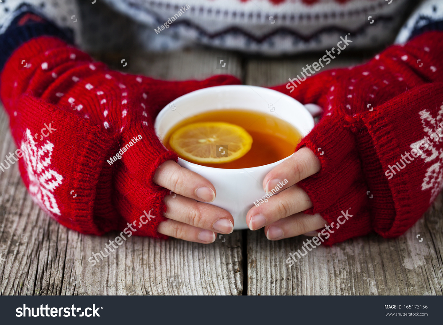 Hands holding a cup of tea