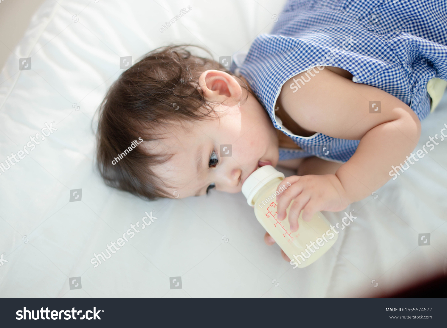 The little girl is drinking milk happily