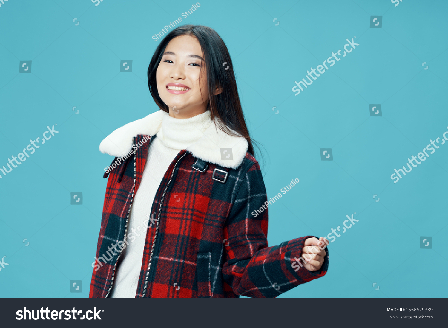 Beautiful woman asian appearance winter jacket fun smile blue isolated background