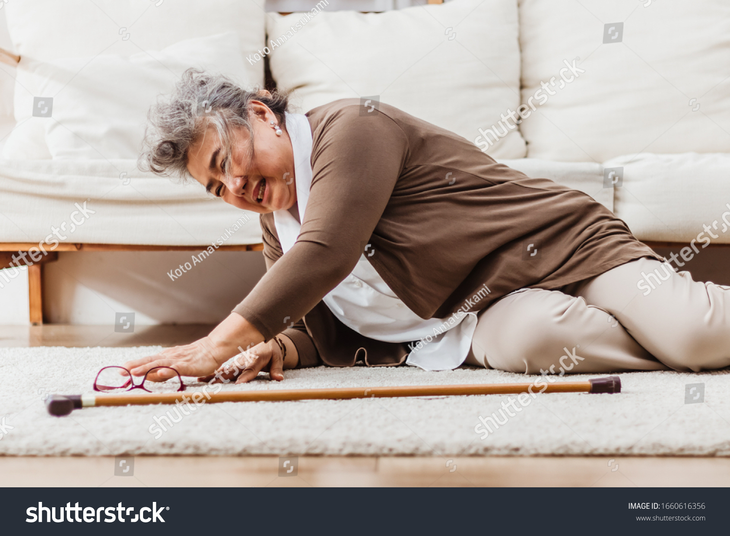 Asian senior woman falling down lying on floor at home alone. Elderly woman pain and hurt from osteoporosis sickness or heart attack. Old adult life insurance with hearlth care and treatment concept